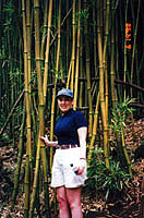 Lesli posing in front of bamboo