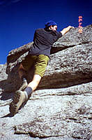 Aaron climbing a steep cliff